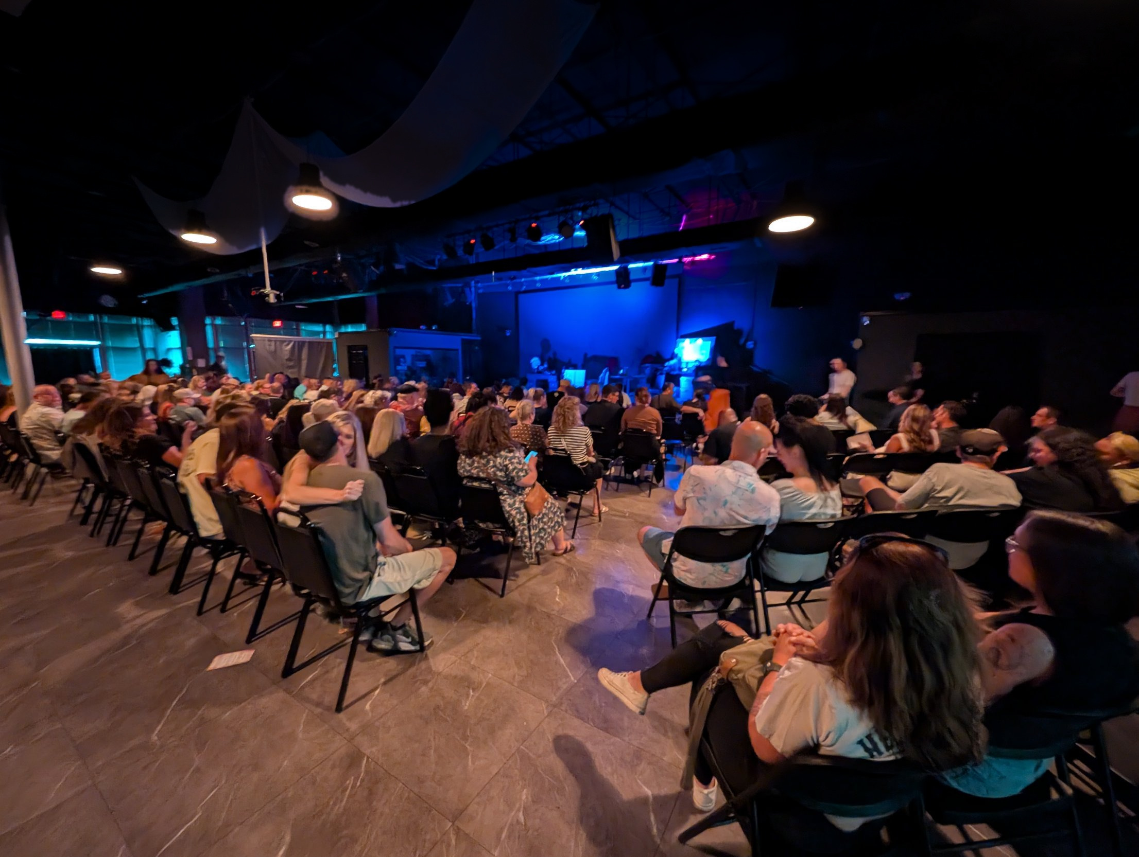 A full house in theater seating facing the La Familia stage