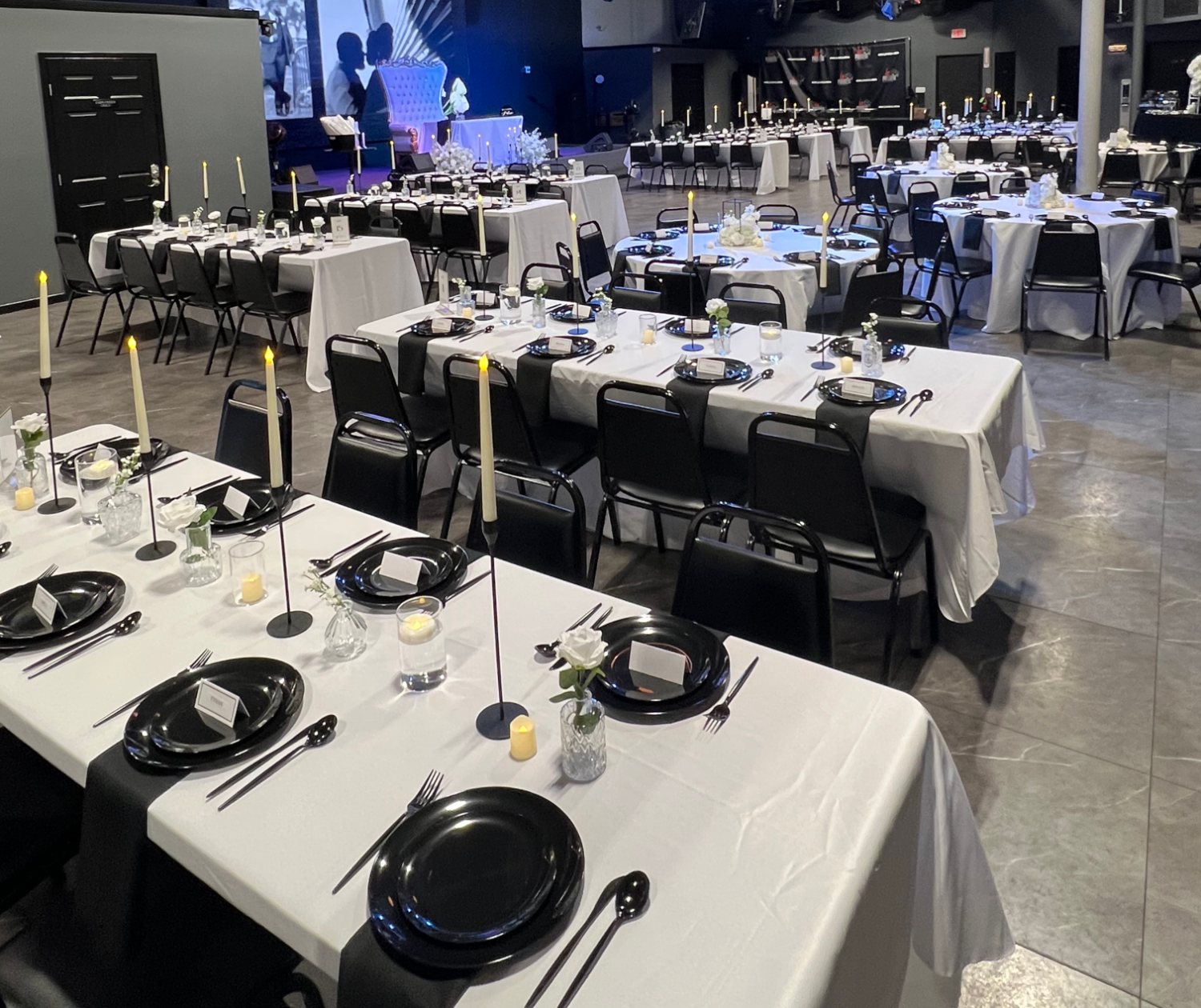 Banquet tables set for a seated dinner at La Familia