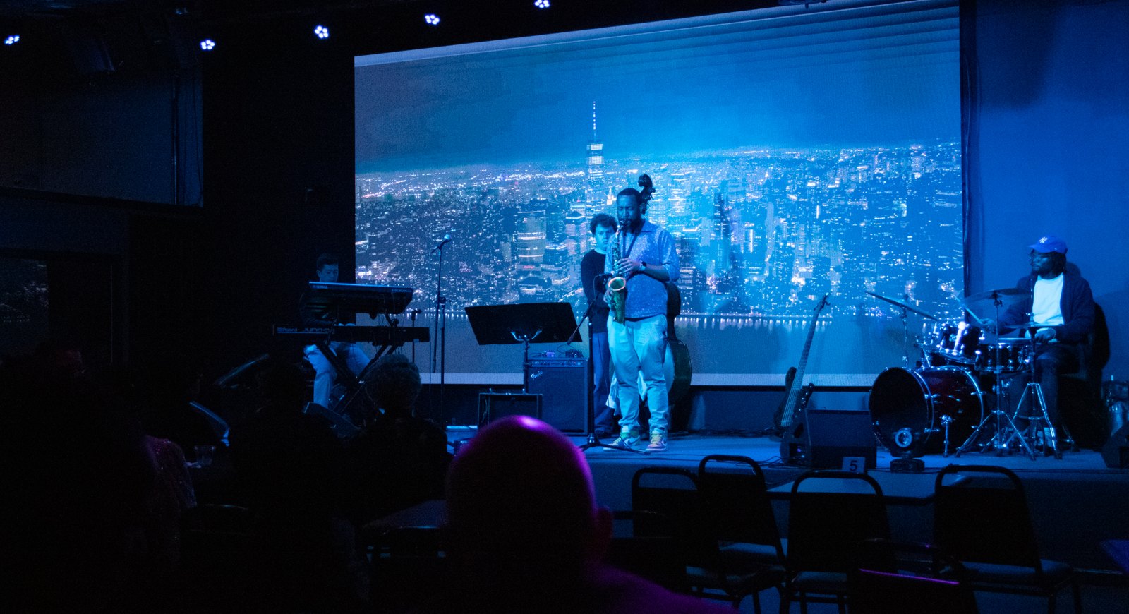 Guests raising a toast during a live performance in front of the La Familia LED wall
