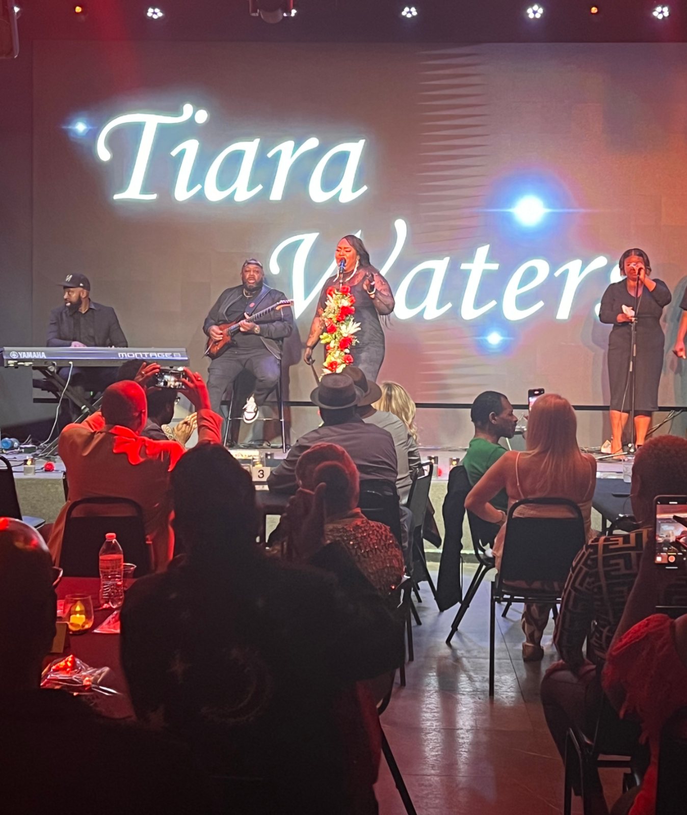 A live band performing for a full dinner crowd at La Familia