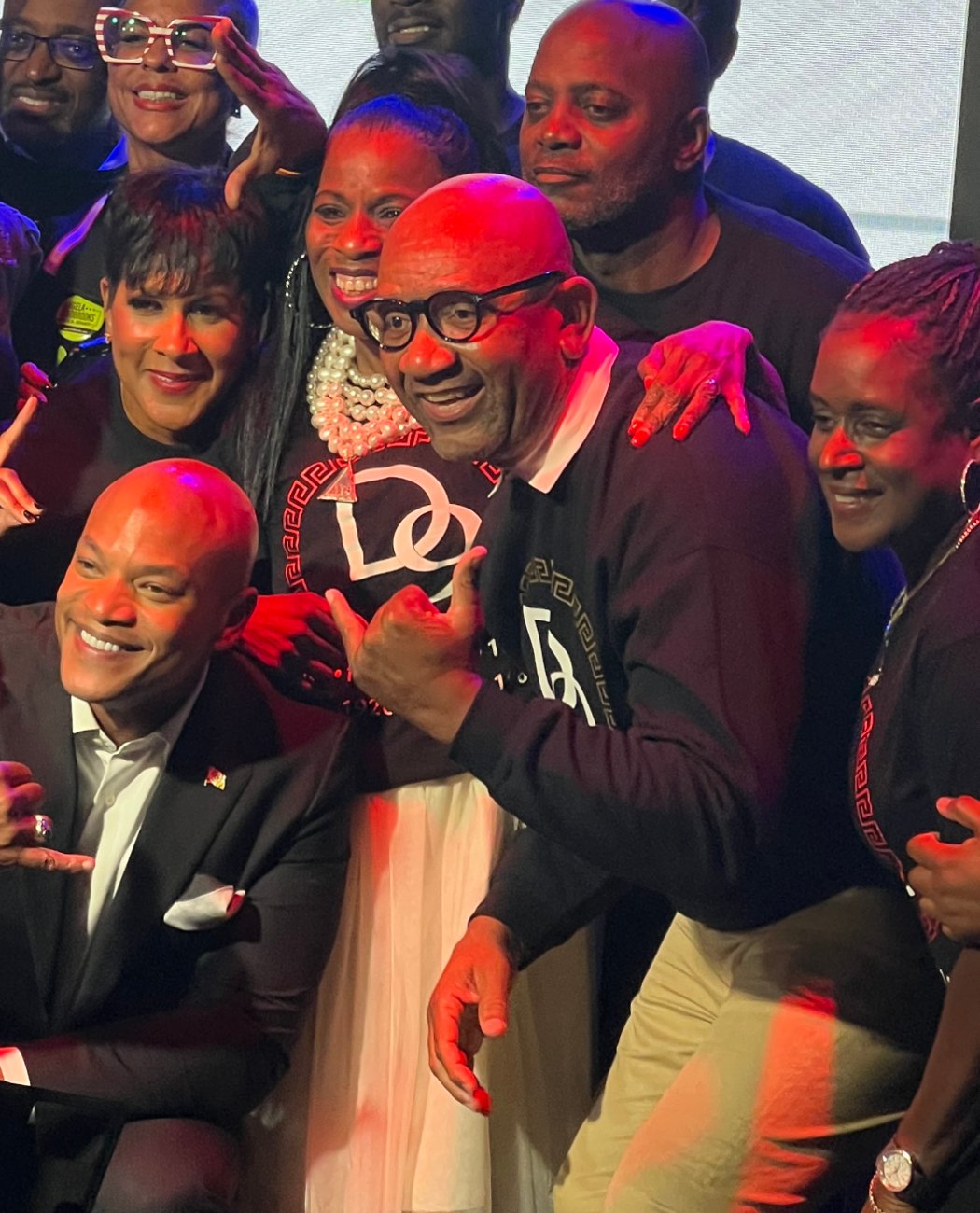 Governor Wes Moore with guests on stage at La Familia