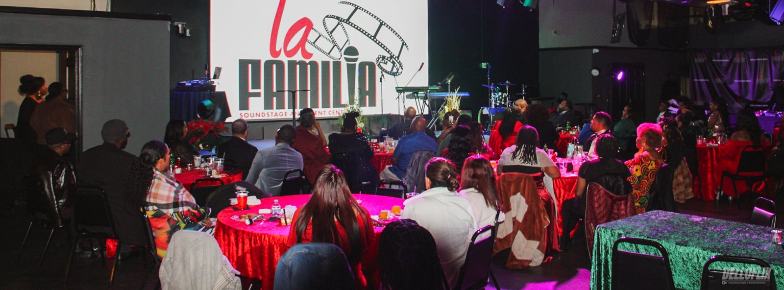 Banquet tables with red and green linens set for a gala at La Familia